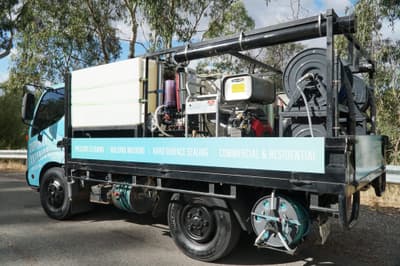 Commercial pressure cleaning Adelaide in progress on a building exterior.