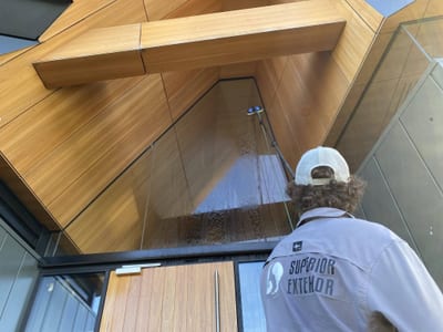 Window Cleaning Adelaide? on a modern wooden and glass facade.