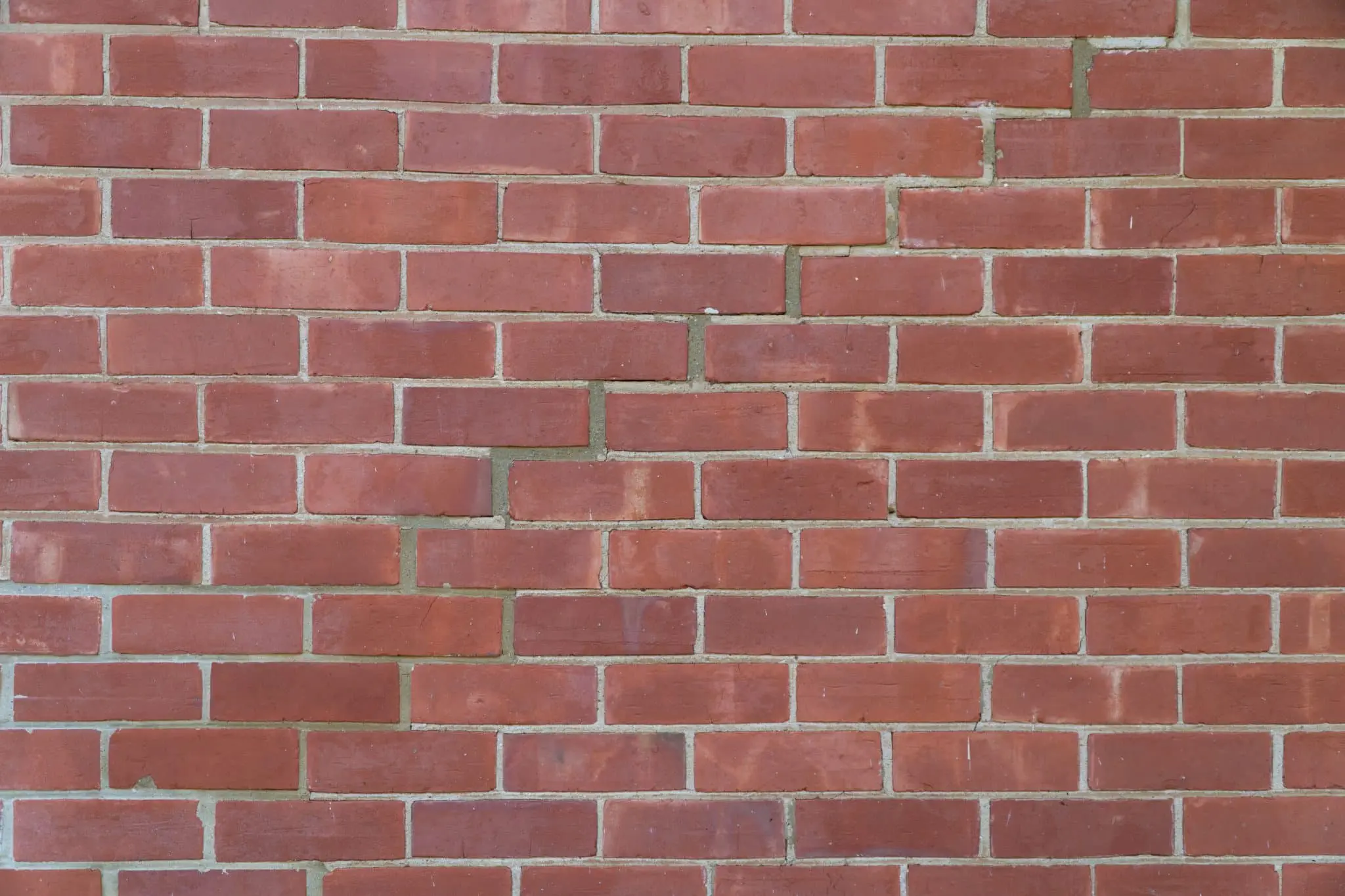 Clean brick wall with vibrant red tones.