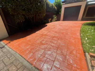After cleaning, vibrant and restored red driveway.
