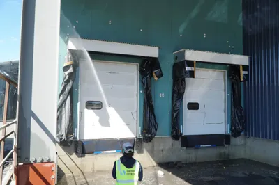 The loading bay in Adelaide is being cleaned with pressure washing.