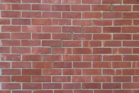 Clean brick wall with vibrant red tones.